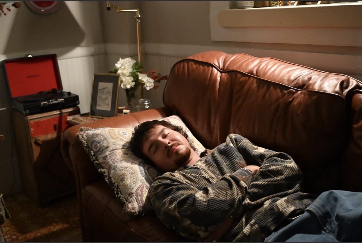 Person relaxing on a couch in the evening before bed