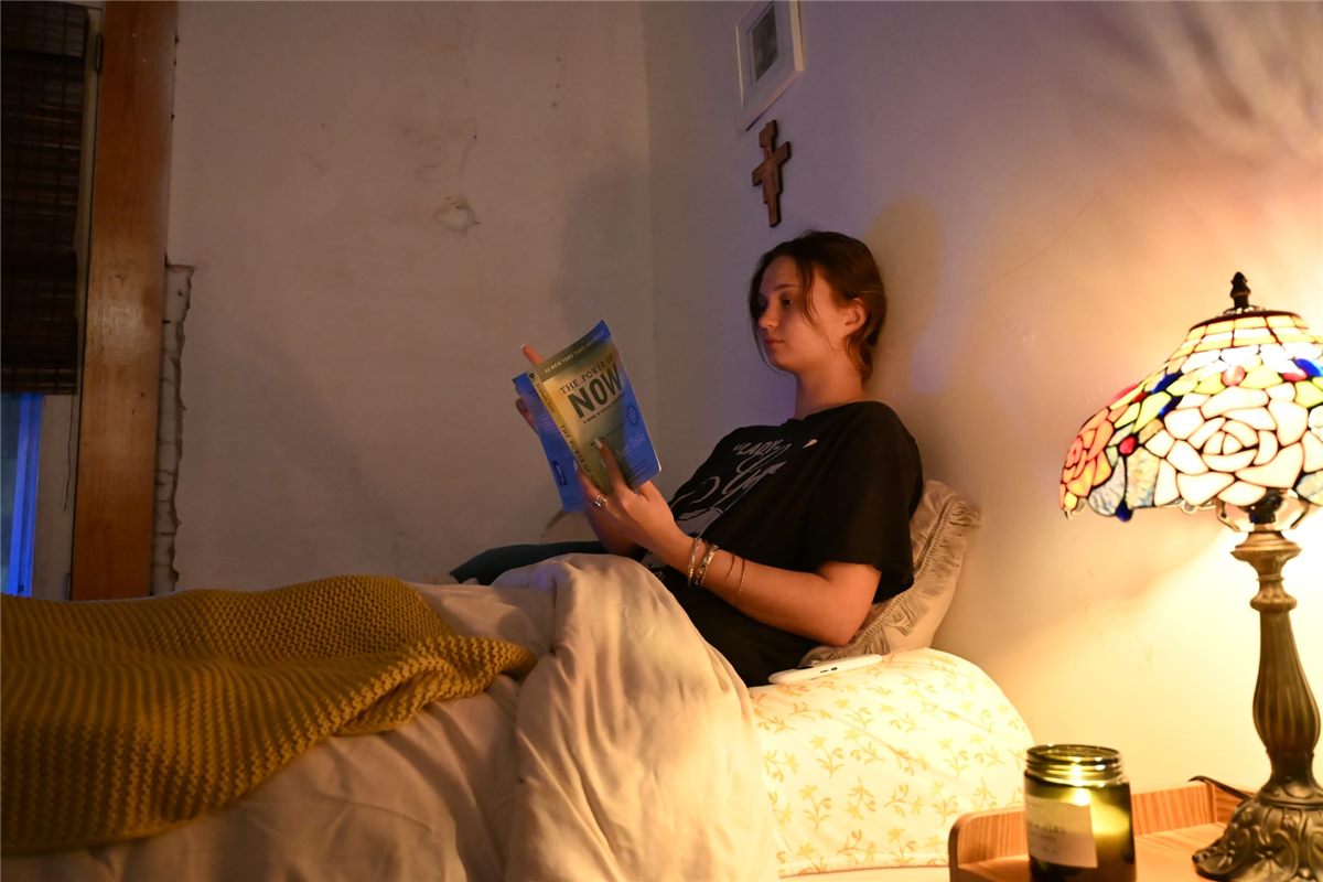 Person reading in warm light as part of an evening wind-down routine