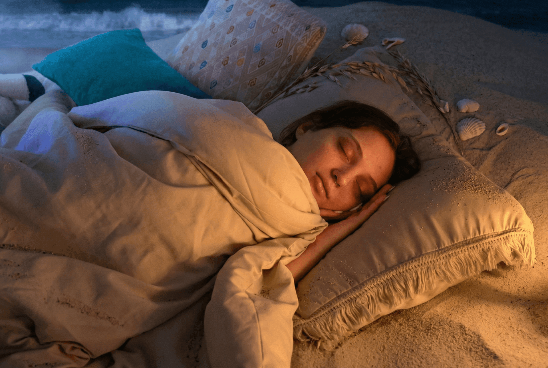 Woman sleeping peacefully in a cozy, softly lit bed