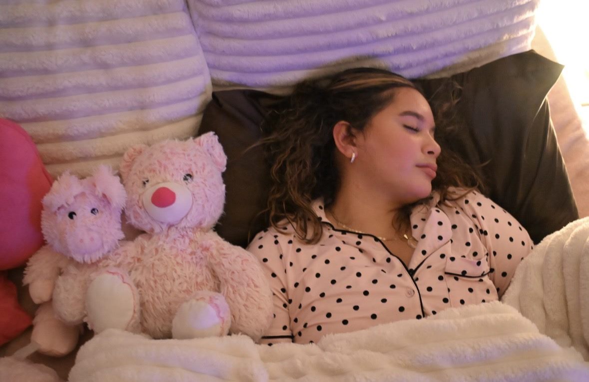 Woman sleeping soundly in a softly lit bedroom